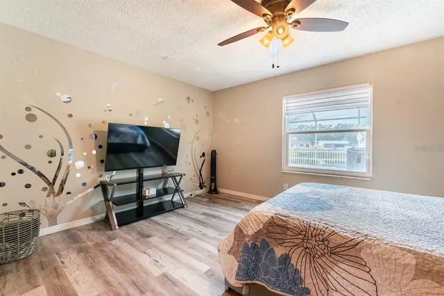 a bedroom with a bed and a chandelier