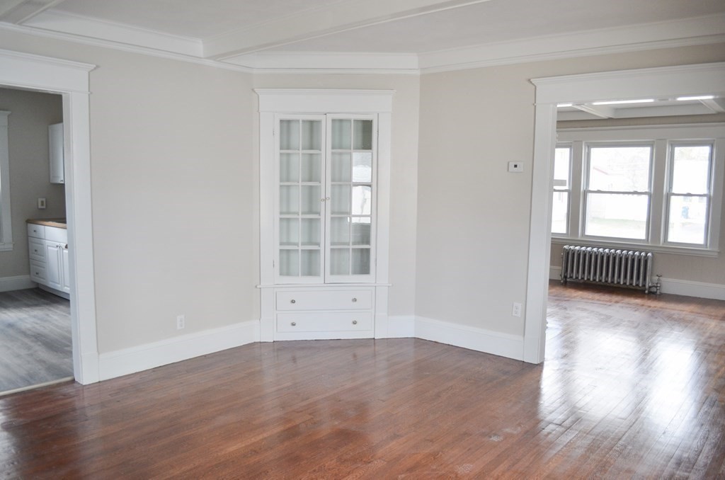 25 Eton Street Springfield, MA 01108 - Photo 12 of 31 an empty room with wooden floor and windows