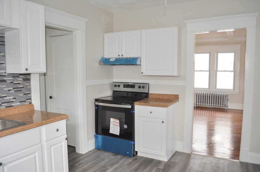 25 Eton Street Springfield, MA 01108 - Photo 4 of 31 a kitchen with granite countertop a stove and a sink