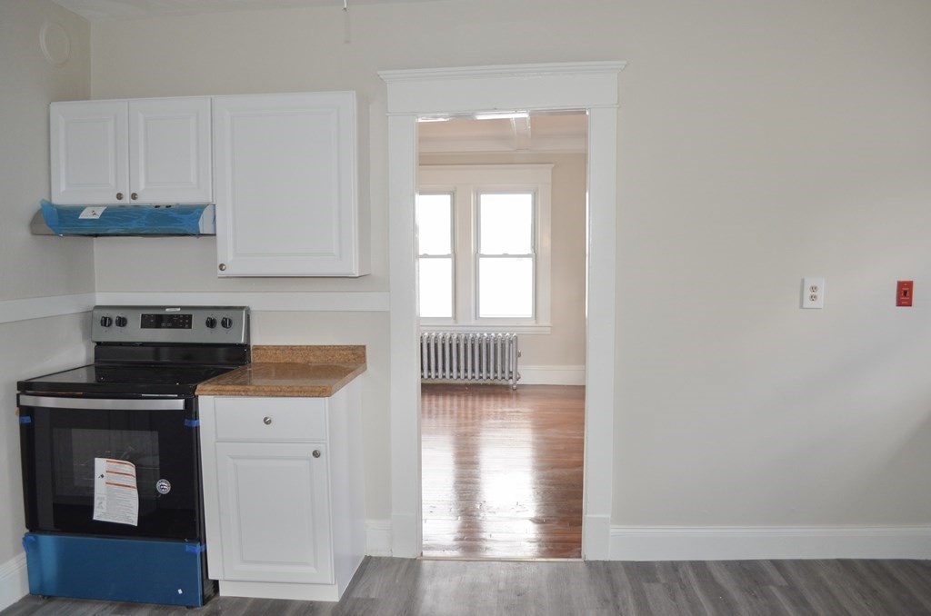 25 Eton Street Springfield, MA 01108 - Photo 5 of 31 a kitchen with a refrigerator and a stove top oven