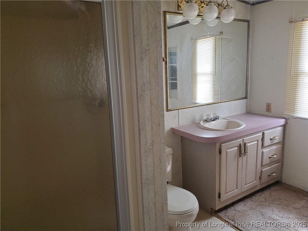 50 Old Forte Trail Spring Lake, NC 28390 - Photo 17 of 20 a bathroom with a granite countertop sink toilet and mirror