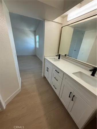 a bathroom with a double vanity sink and mirror
