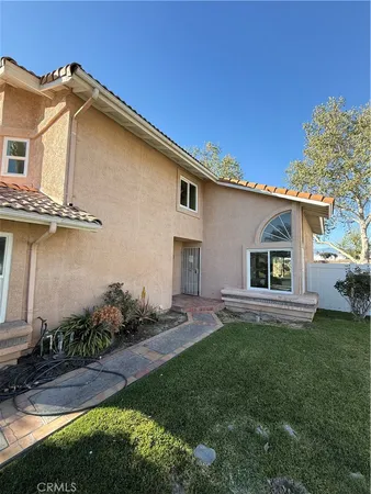 a front view of a house with a garden and yard