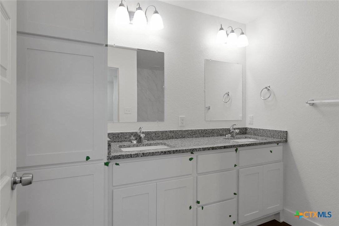 1924 Royal Loop Belton, TX 76513 - Photo 13 of 15 a bathroom with a granite countertop sink and a mirror