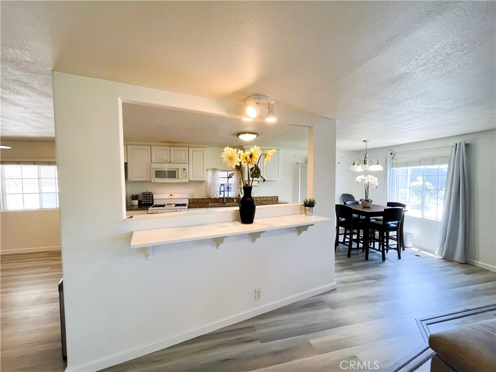 17700 Avalon Boulevard, Unit 40 Carson, CA 90746 - Photo 11 of 32 a view of kitchen with dining table wooden floor and living room