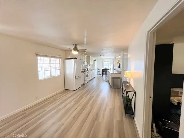 a view of a living room hardwood floor and a kitchen