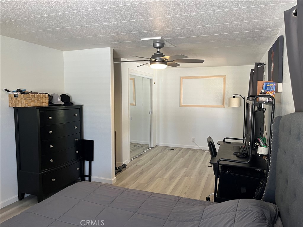 17700 Avalon Boulevard, Unit 40 Carson, CA 90746 - Photo 18 of 32 a bedroom with a bed and wooden floor