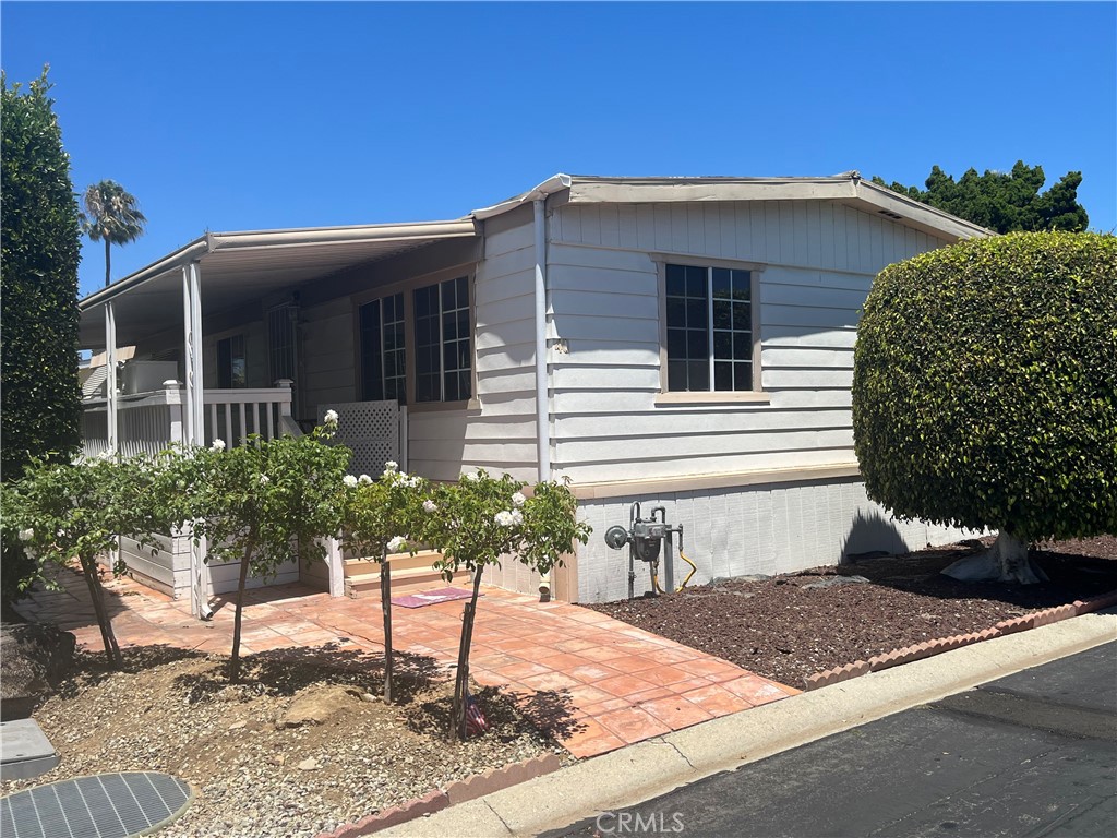 17700 Avalon Boulevard, Unit 40 Carson, CA 90746 - Photo 2 of 32 a front view of a house with garden