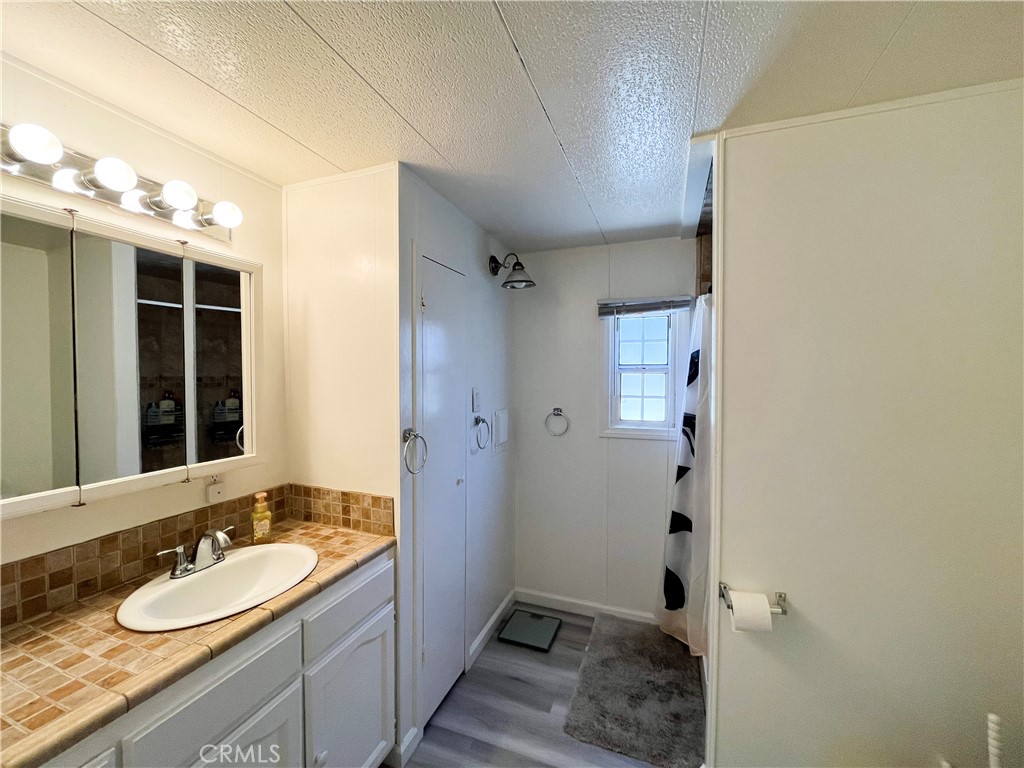 17700 Avalon Boulevard, Unit 40 Carson, CA 90746 - Photo 21 of 32 a bathroom with a granite countertop sink toilet and shower
