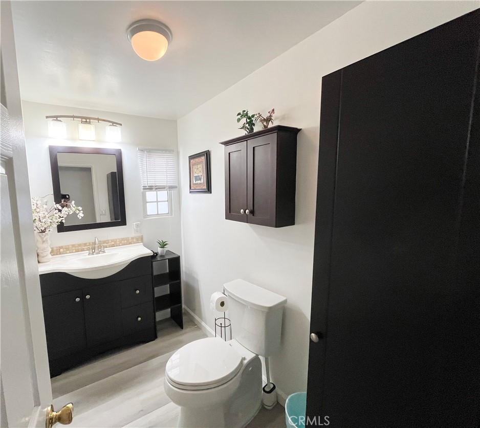 17700 Avalon Boulevard, Unit 40 Carson, CA 90746 - Photo 26 of 32 a bathroom with a toilet sink vanity granite and mirror