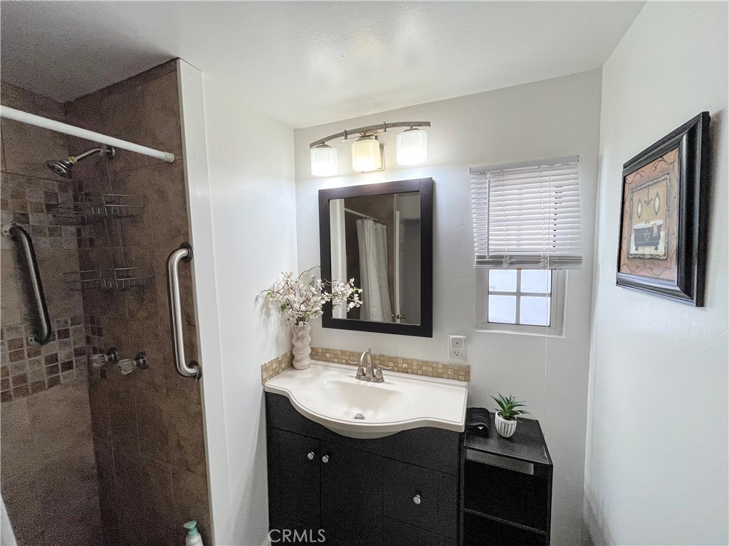 17700 Avalon Boulevard, Unit 40 Carson, CA 90746 - Photo 27 of 32 a bathroom with a sink a mirror and a shower