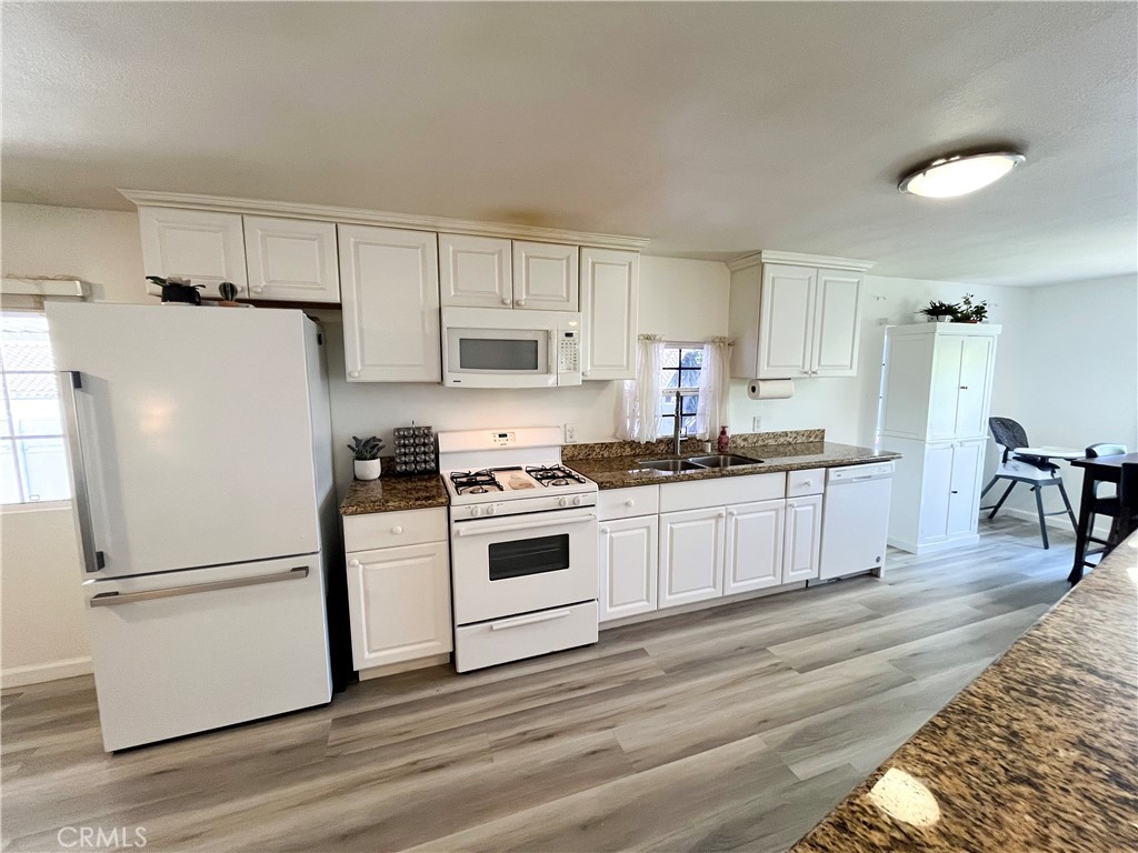 17700 Avalon Boulevard, Unit 40 Carson, CA 90746 - Photo 4 of 32 a kitchen with white cabinets and white appliances