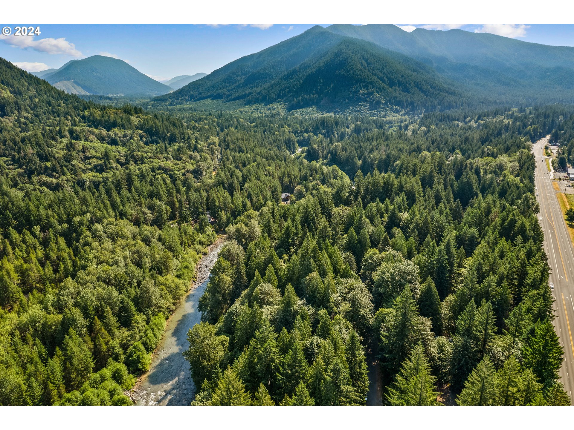 East Vine Maple Drive Rhododendron, OR 97049 - Photo 13 of 18 a view of a lush green hillside and a houses