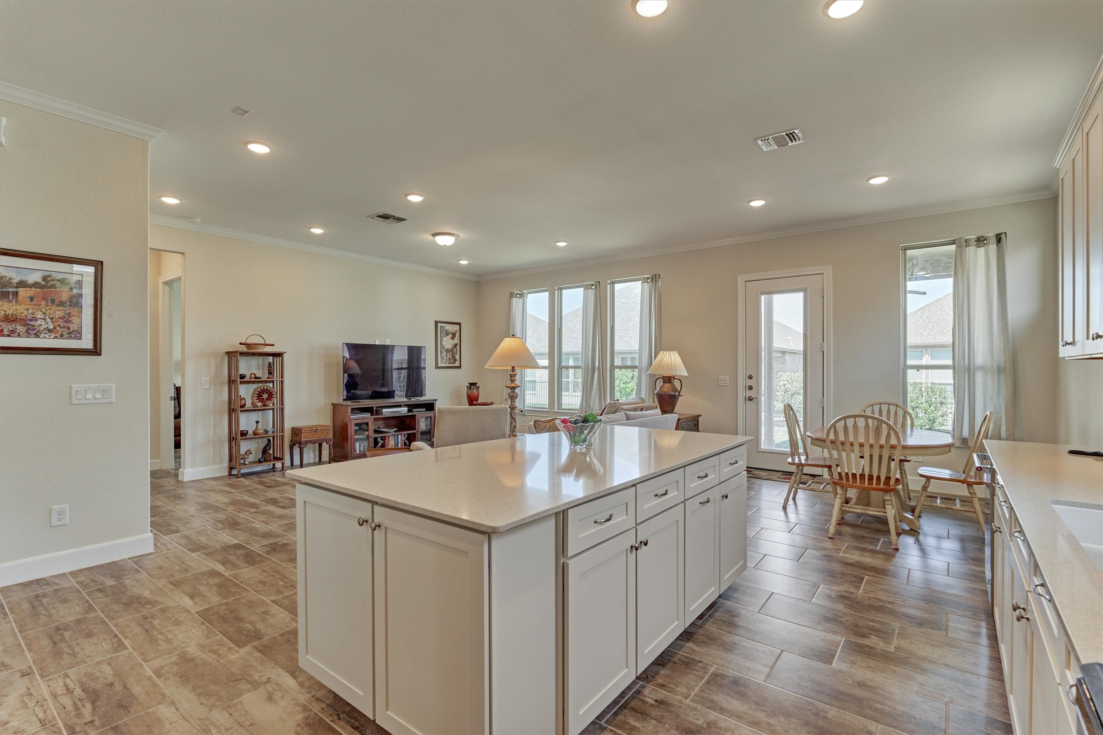 132 Chestnut Bay Spring, TX 77382 - Photo 22 of 33 a large kitchen with kitchen island a sink table and chairs