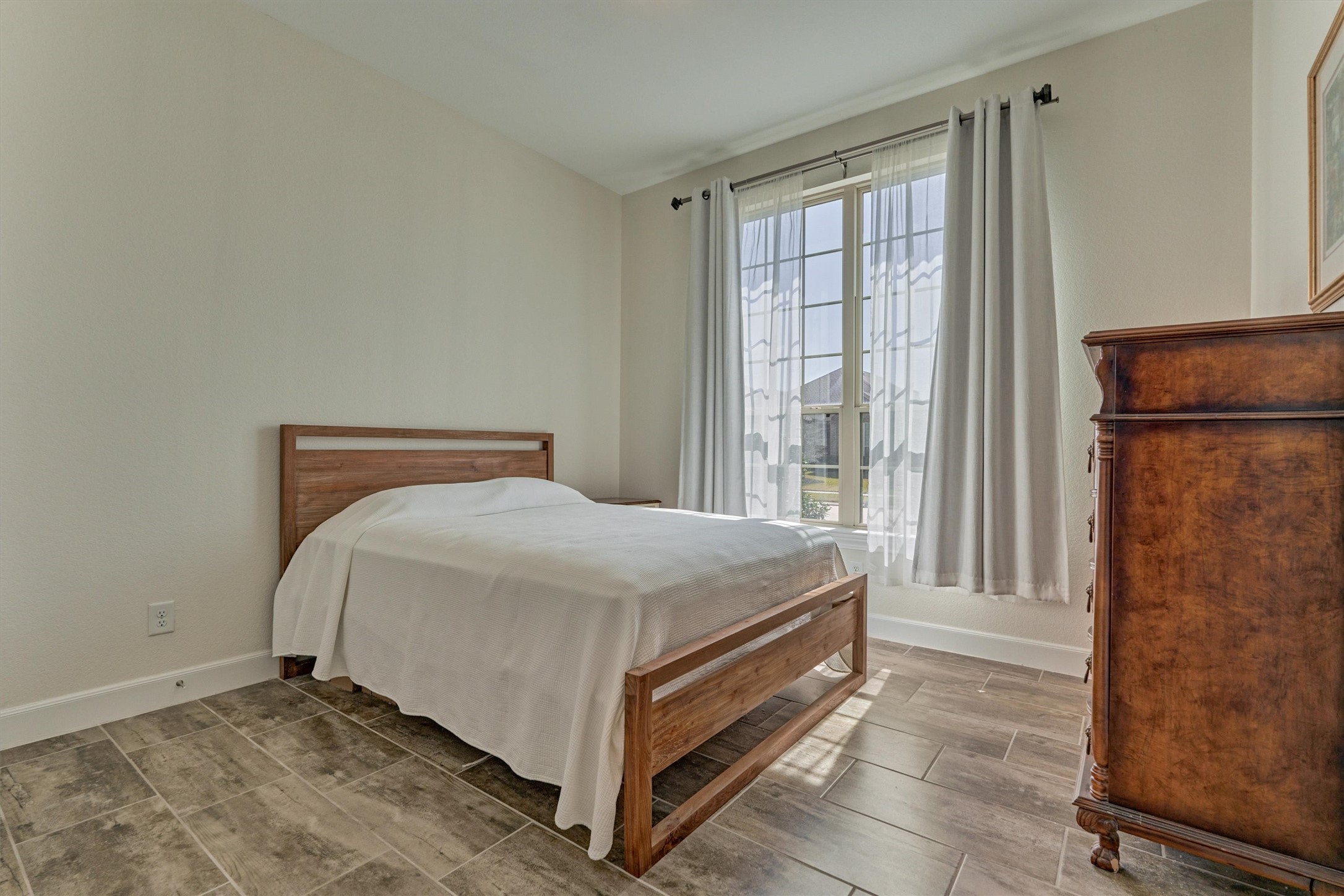 132 Chestnut Bay Spring, TX 77382 - Photo 6 of 33 a bed sitting in a bedroom next to a window