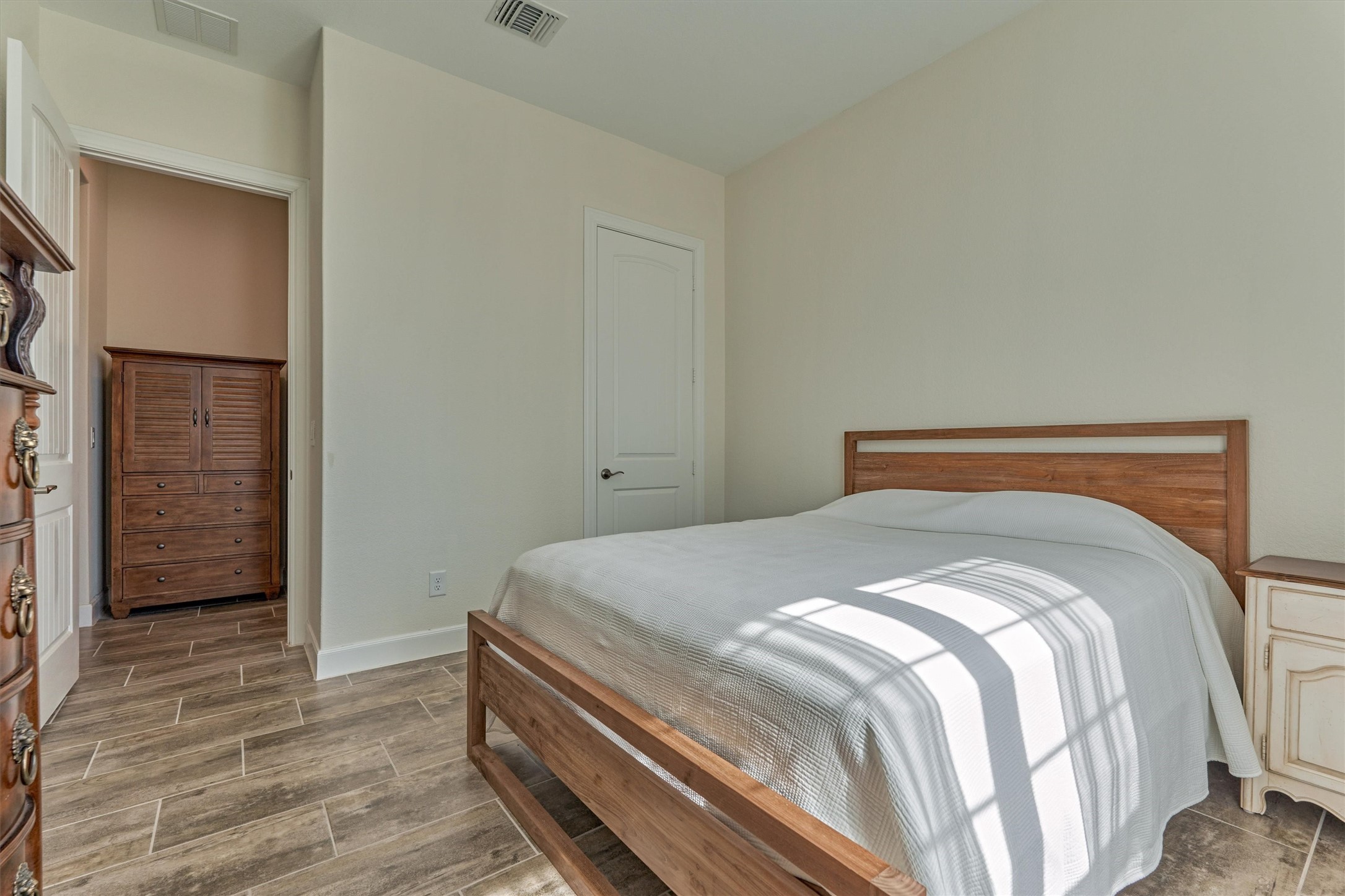 132 Chestnut Bay Spring, TX 77382 - Photo 7 of 33 a bedroom with a bed and wooden floor