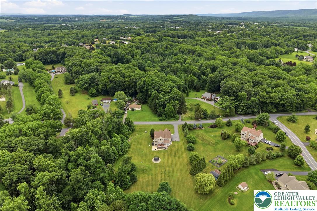 1212 Miller Road Wind Gap, PA 18091 - Photo 72 of 72 Perched on an expansive lot amidst mature trees, this residence offers a serene, elevated perspective of the surrounding natural beauty.