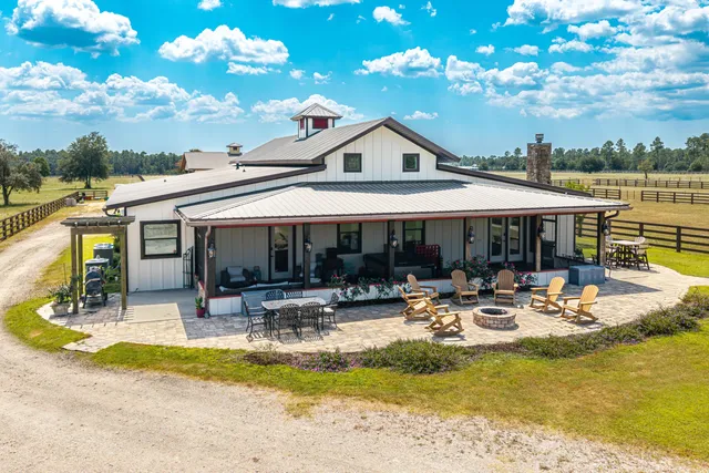 a living room with stainless steel appliances kitchen island granite countertop furniture and a large window
