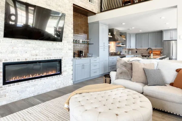 a living room with furniture a fireplace and a flat screen tv