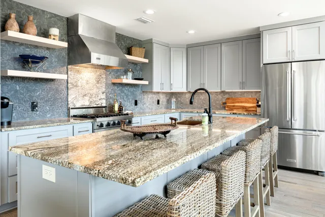 a kitchen with stainless steel appliances granite countertop a refrigerator sink and stove