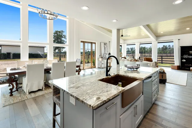 a view of a livingroom with furniture and floor to ceiling window