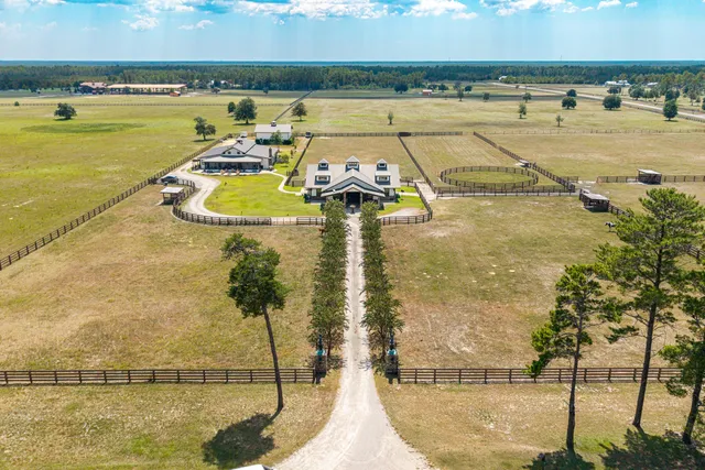 a view of a house with swimming pool and a yard