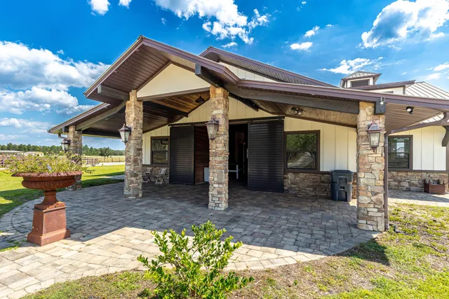 a view of a house with swimming pool and sitting area