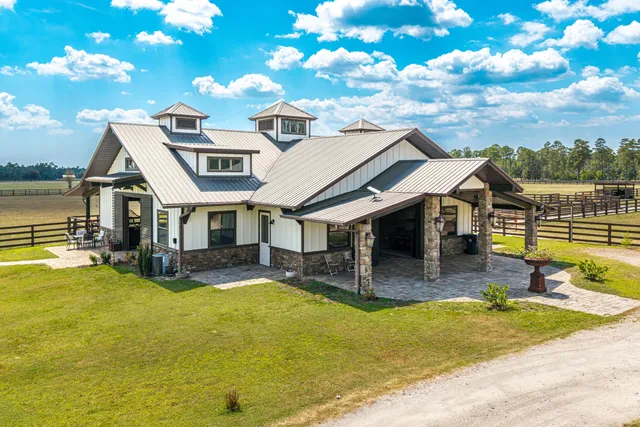 a view of a house with swimming pool and sitting area