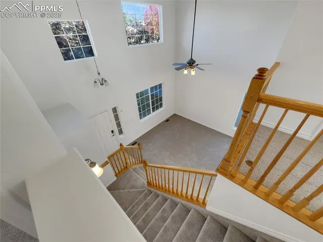 a view of staircase with white walls and a window