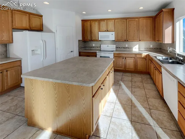 a kitchen with stainless steel appliances granite countertop a sink counter space cabinets and a large window