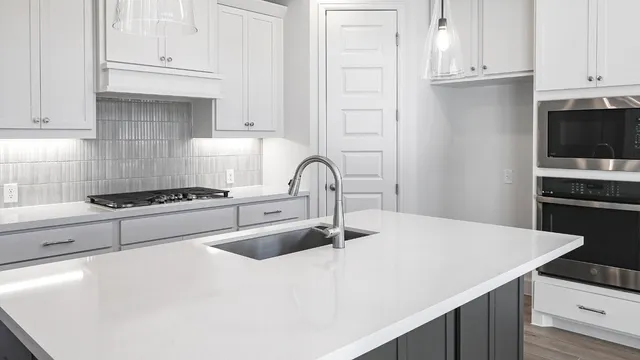 a kitchen with a sink stainless steel appliances and cabinets