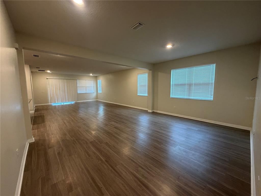 9448 Sanders Pk Place Seffner, FL 33584 - Photo 14 of 21 an empty room with wooden floor and windows
