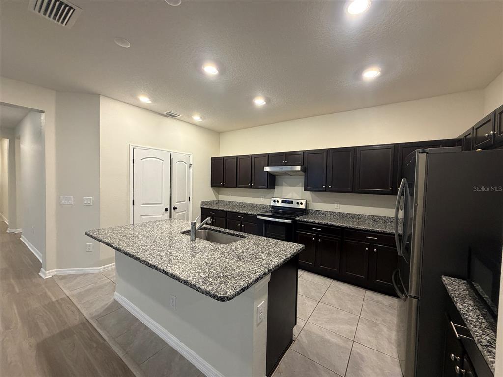9448 Sanders Pk Place Seffner, FL 33584 - Photo 16 of 21 a kitchen with stainless steel appliances granite countertop a sink counter space and cabinets