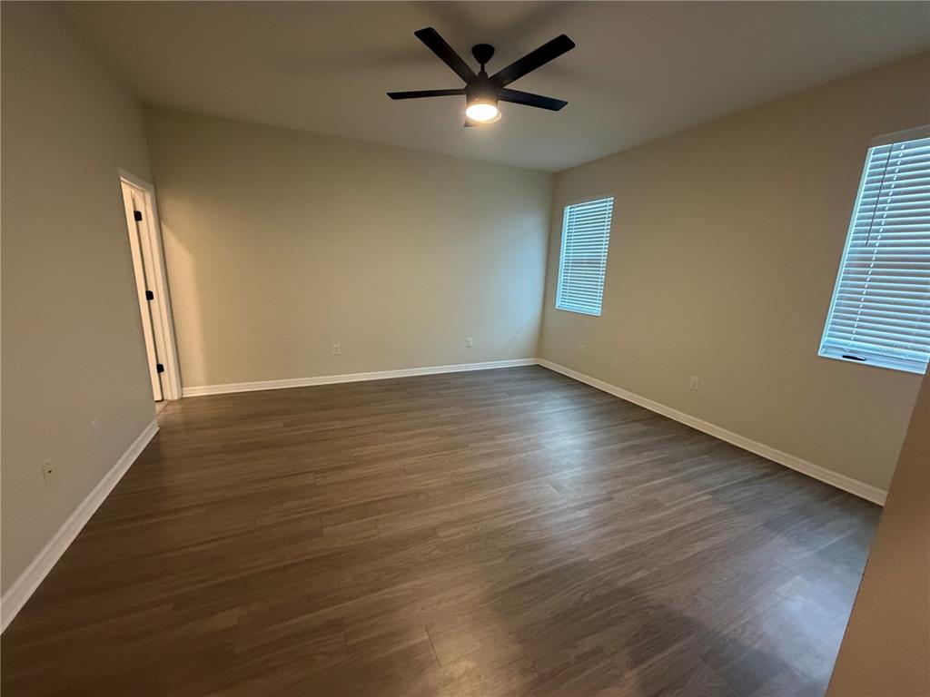 9448 Sanders Pk Place Seffner, FL 33584 - Photo 18 of 21 a view of an empty room with wooden floor and a window