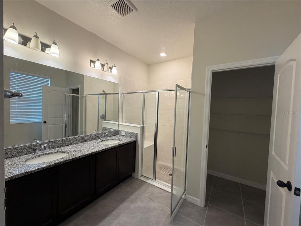 9448 Sanders Pk Place Seffner, FL 33584 - Photo 21 of 21 a bathroom with a double vanity sink and a mirror