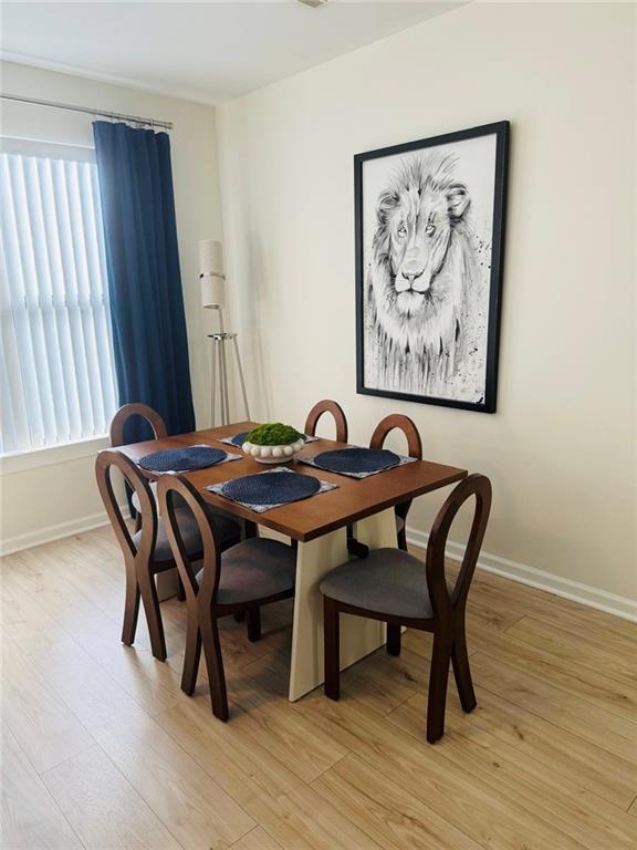 898 Oak Street Southwest, Unit 1214 Atlanta, GA 30310 - Photo 7 of 23 a view of a dining room with furniture and wooden floor