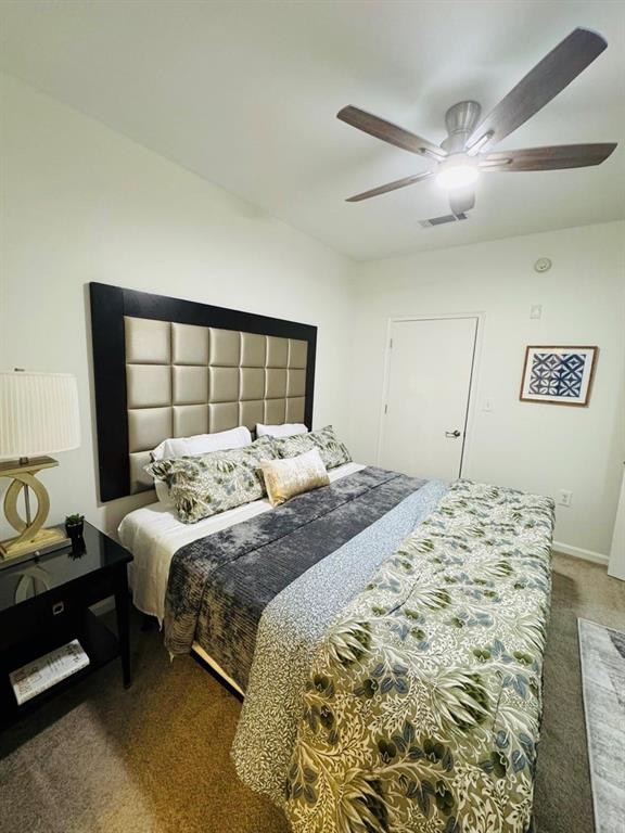 898 Oak Street Southwest, Unit 1214 Atlanta, GA 30310 - Photo 9 of 23 a bedroom with a large bed and a chandelier