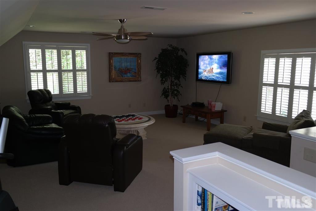 12928 Victory Church Road Raleigh, NC 27613 - Photo 22 of 25 a living room with furniture and a flat screen tv
