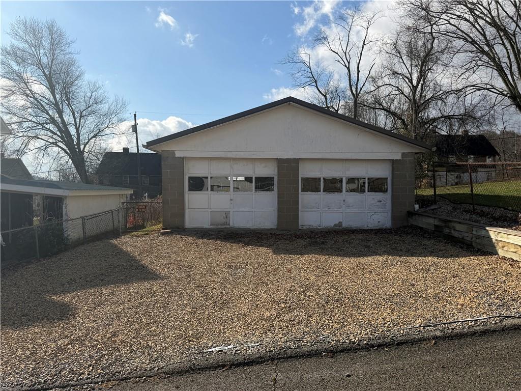 a house that has a tree in front of it