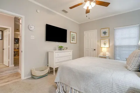 a bedroom with a flat screen tv and a bed