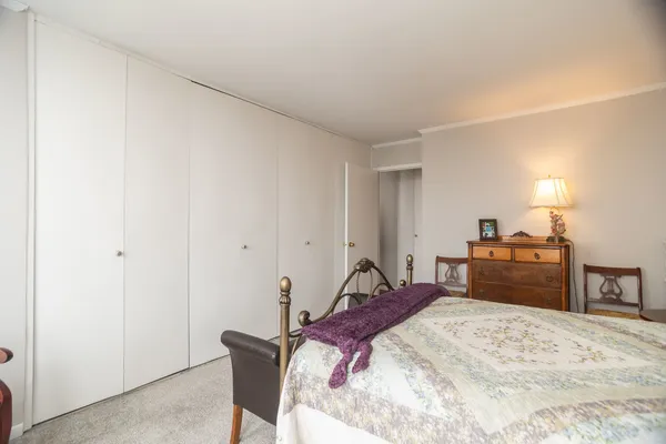 a bed room with a bed and a television