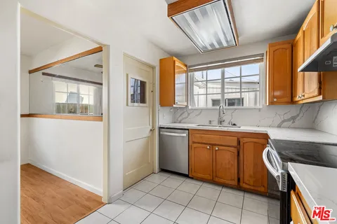 a kitchen with a sink cabinets and window