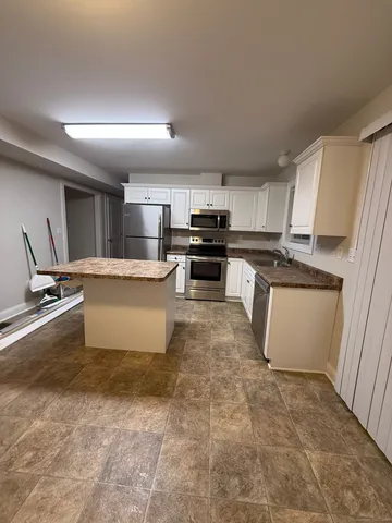 a kitchen with a stove a sink and a refrigerator