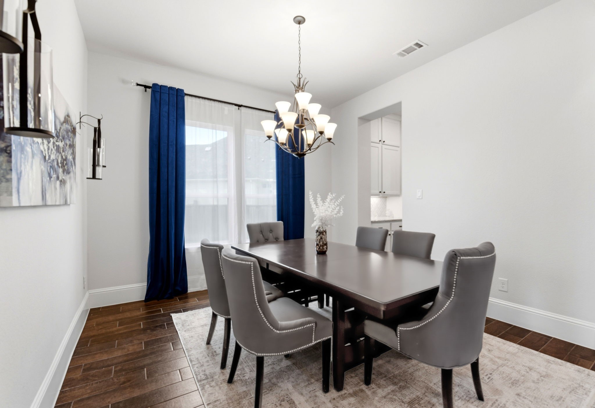 10062 South Goshawk Trail Conroe, TX 77385 - Photo 8 of 43 a view of a dining room with furniture wooden floor and chandelier