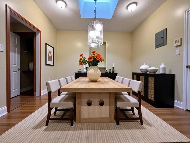 a view of a dining room with furniture wooden floor and a chandelier
