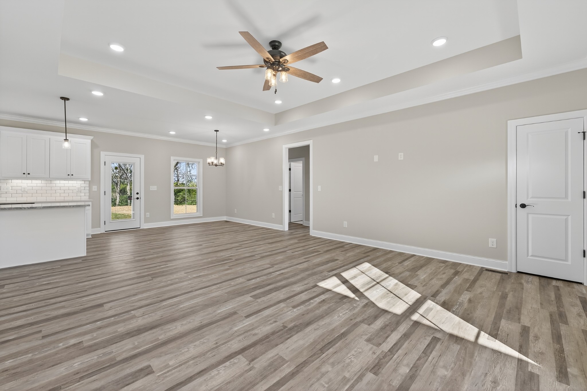 702 Meadow Road Mount Pleasant, TN 38474 - Photo 15 of 51 a view of an empty room with wooden floor and a ceiling fan