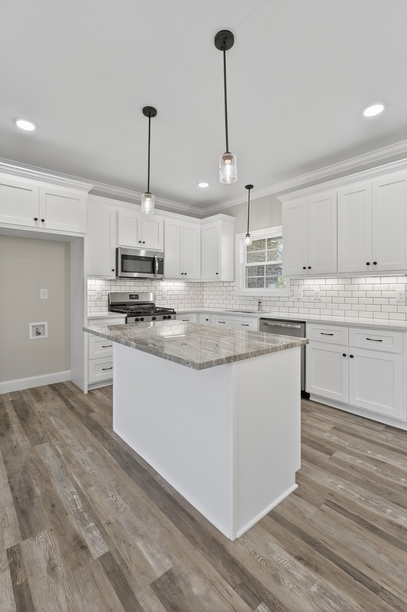 702 Meadow Road Mount Pleasant, TN 38474 - Photo 16 of 51 a kitchen with stainless steel appliances granite countertop a sink a stove a refrigerator and white cabinets