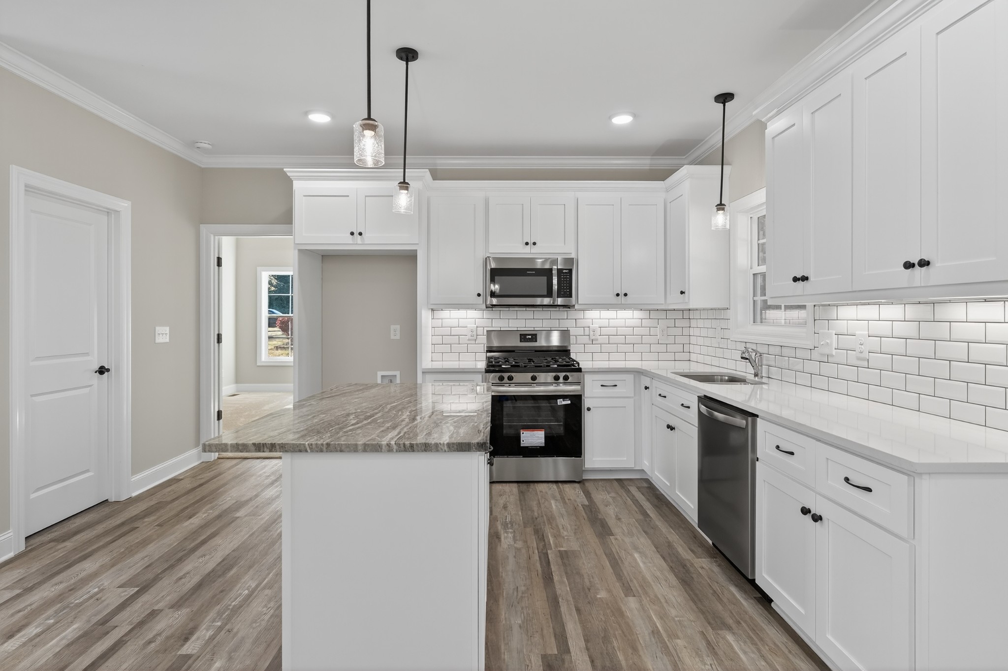 702 Meadow Road Mount Pleasant, TN 38474 - Photo 17 of 51 a kitchen with kitchen island granite countertop a sink cabinets and stainless steel appliances