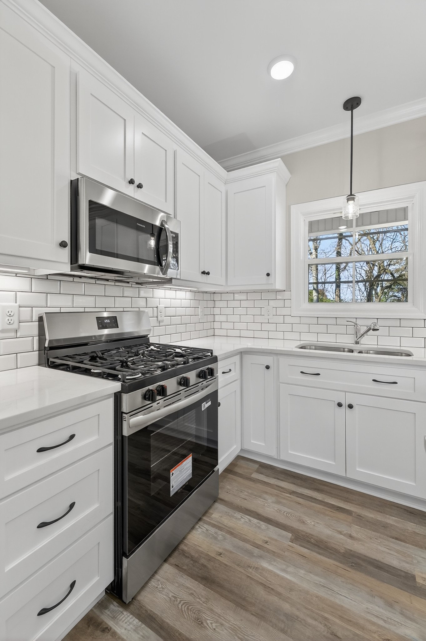 702 Meadow Road Mount Pleasant, TN 38474 - Photo 22 of 51 a kitchen with white cabinets stainless steel appliances and sink