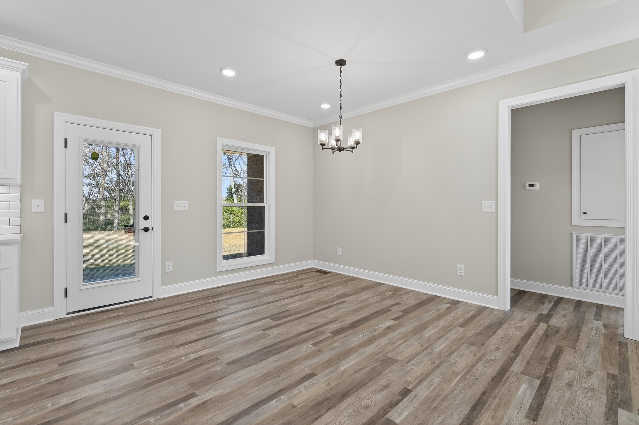 702 Meadow Road Mount Pleasant, TN 38474 - Photo 24 of 51 a view of an empty room with wooden floor and a window